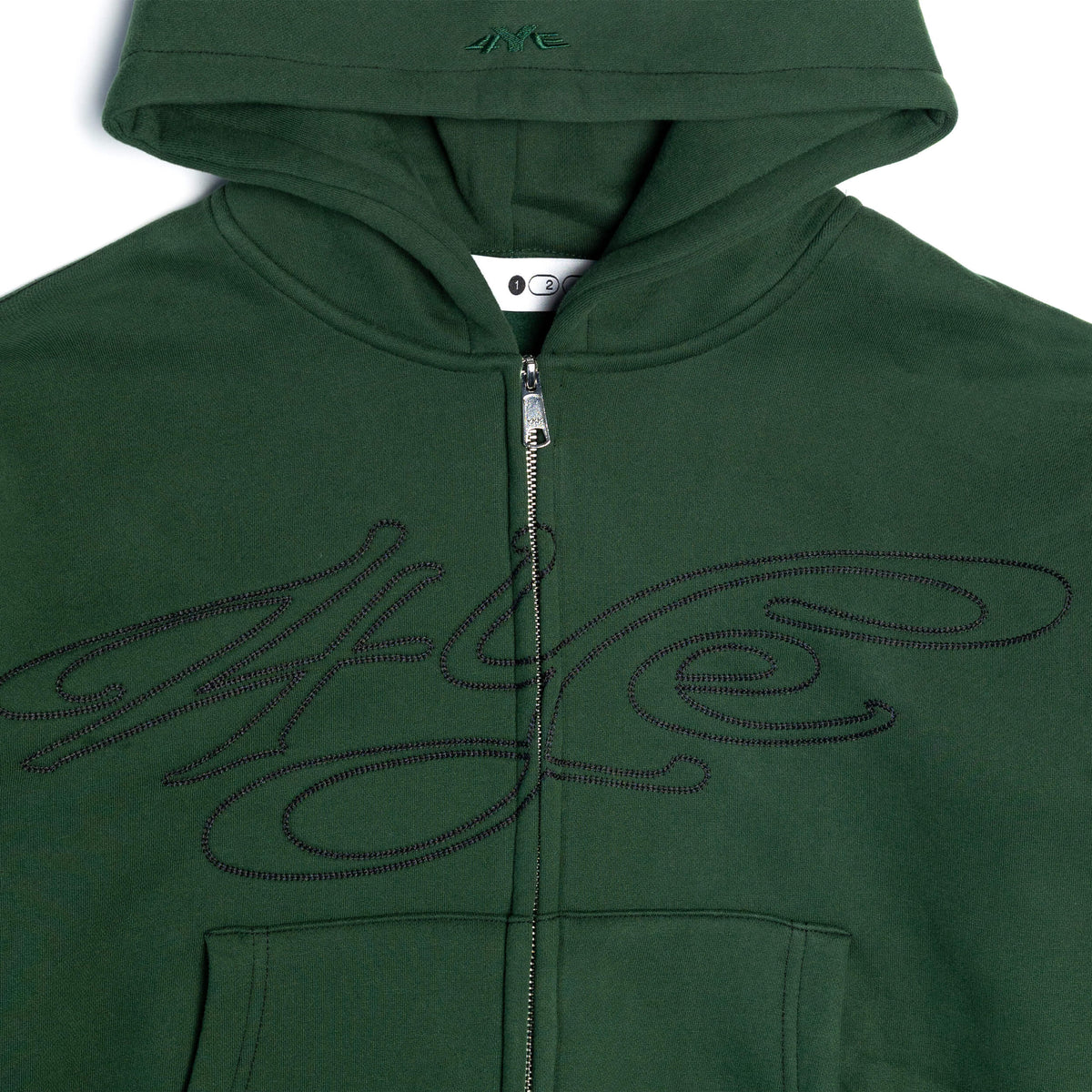 Close up of dark green zip up hoodie with signature logo on a white background
