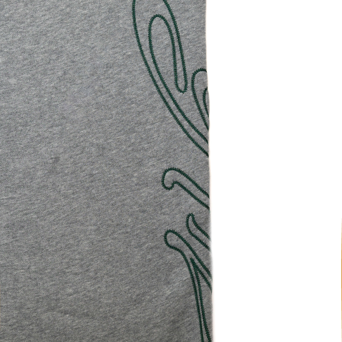 close up of green logo on pant