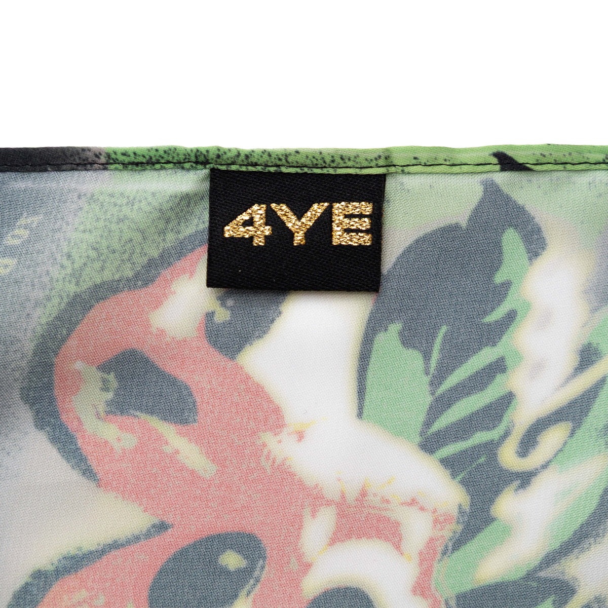 Close-up of a fabric with ackee print and a '4YE' label.