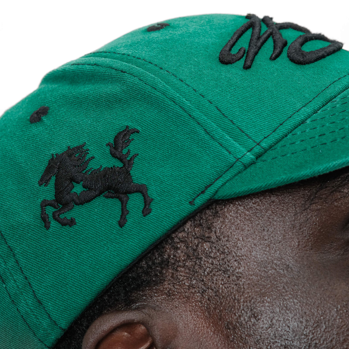 Side view of the low pro in faded green. Side view highlights the 3-D embroidered stallion motif on left panel. 