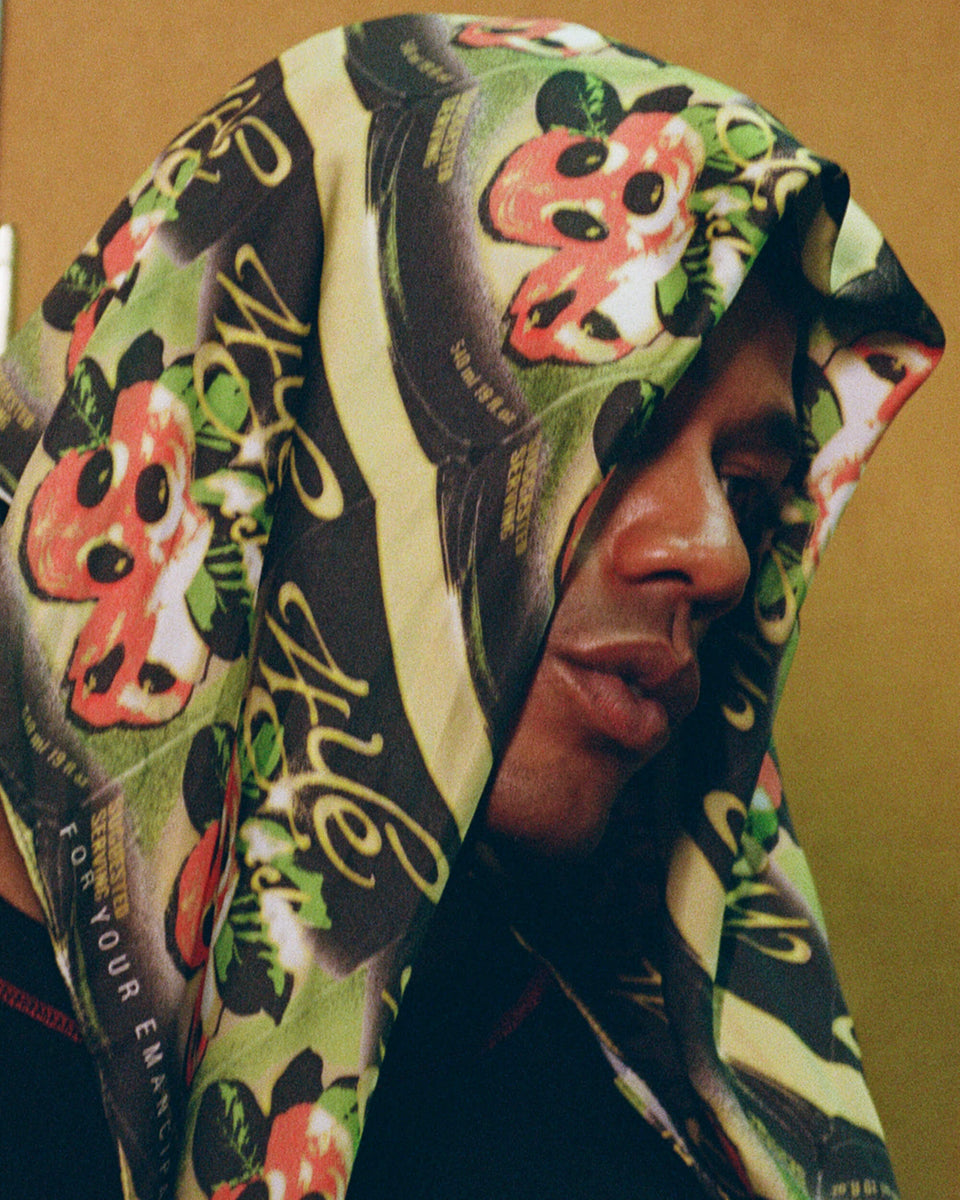 model wearing ackee print scarf over their head