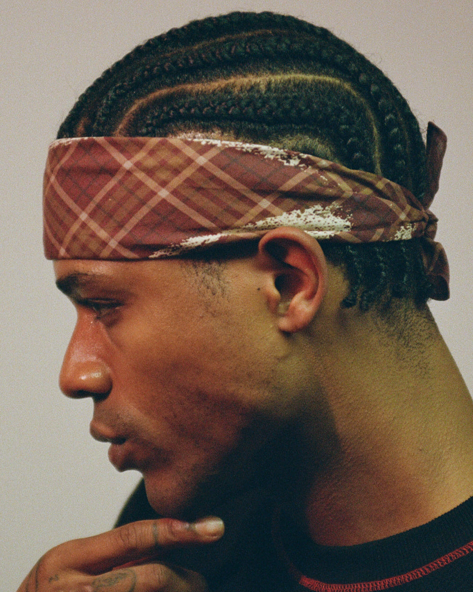 model wearing the scarf as a headband with a neutral background