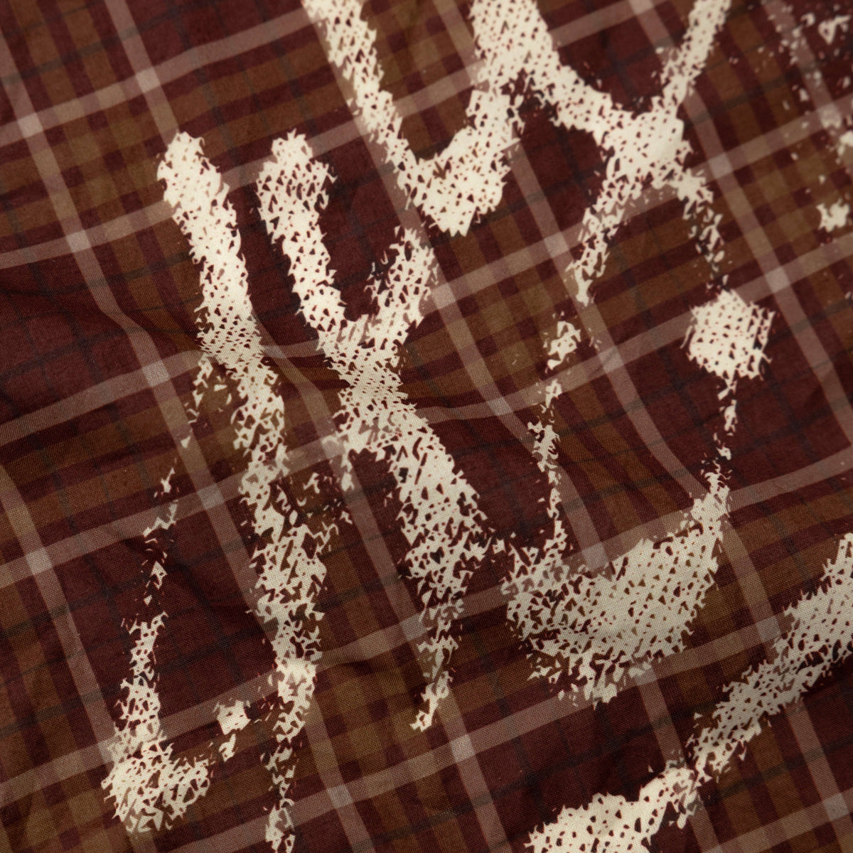 close up of signature logo on the red bandana print scarf